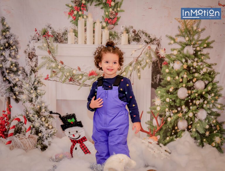 Child posing at the holiday photo backdrop
