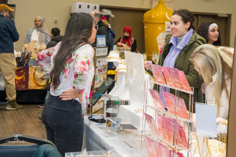 Shoppers browsing a vendor table at the expo